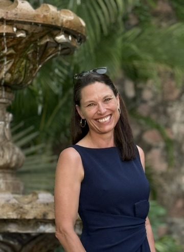 Patty de Vries smiling in the garden at Living Well